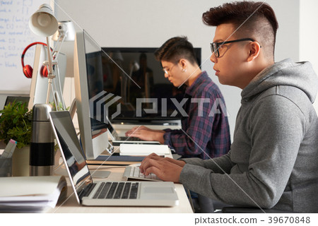Asian Programmers Wrapped up in Work 39670848