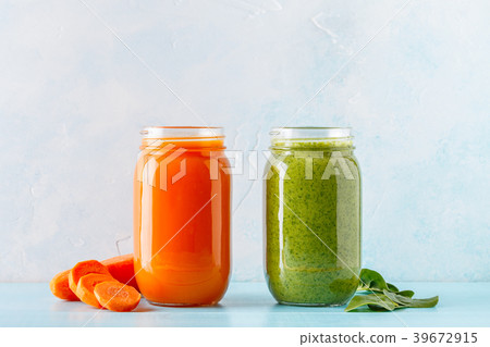 Orange/green colored smoothies / juice in a jar Orange/green colored smoothies / juice in a jar 39672915