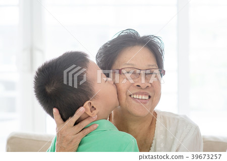 Grandchild kissing grandmother 39673257