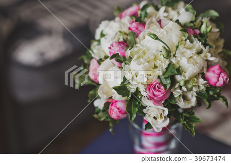 Delicate bouquet of white roses in a vase 457. 39673474