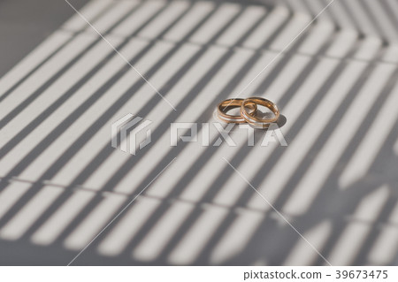 Wedding rings on shadow striped background 459. Wedding rings on shadow striped background 459. 39673475