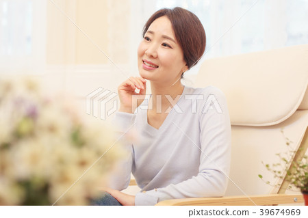 A housewife sitting on a chair 39674969