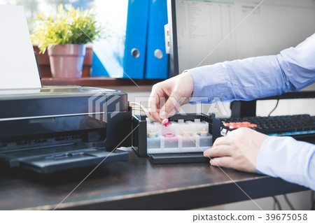 Businessman checks how much ink has been left Businessman checks how much ink has been left 39675058