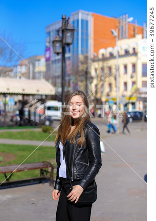 Nice female person walking in city and wearing 39677248