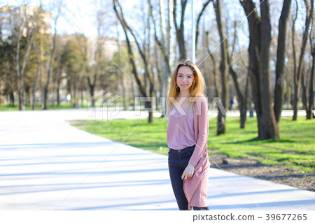 Beautiful girl looking at camera, smiling and Beautiful girl looking at camera, smiling and 39677265