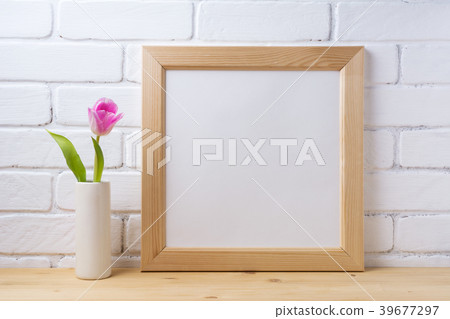Wooden square frame mockup with pink tulip 39677297