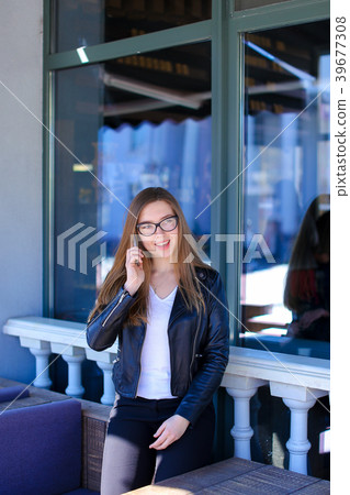 Nice girl in glasses talkingking by smartphone at 39677308