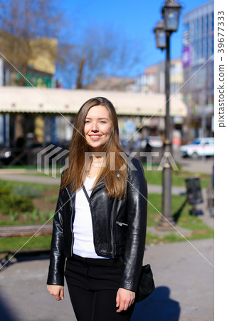 Young woman walkign in city and wearing leather 39677333