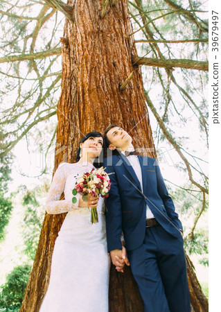 The up view of the throughtful newlyweds leaning 39679497