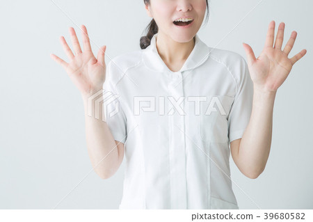 Surprised woman in white coat Surprised woman in white coat 39680582