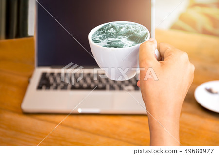 Concept ideal hand holding coffee with ocean wave 39680977