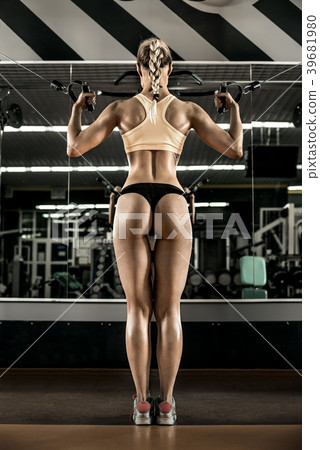young fitness woman execute exercise with exercise-machine Cable 39681980