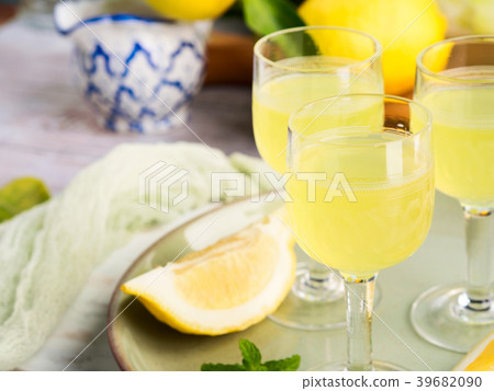 Home made limoncello in stemmed glasses 39682090