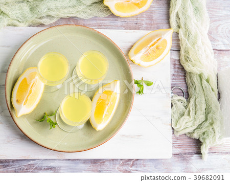 Home made limoncello in stemmed glasses 39682091