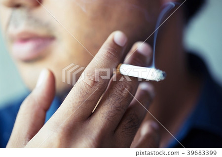 The man smoking a cigarette. Cigarette smoke  39683399