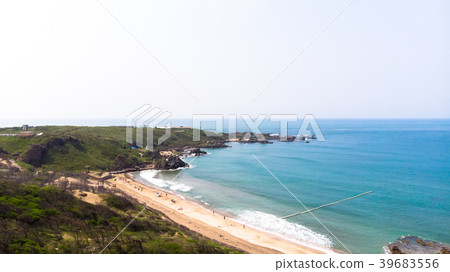 Aerial view of sandy beach with tourists swimming  39683556