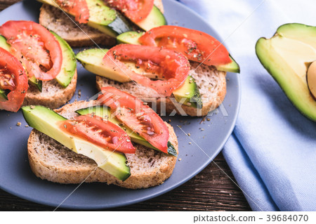 Toast with avocado and tomato slices Toast with avocado and tomato slices 39684070
