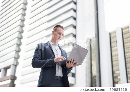 Confident Businessman Using Laptop outdoor. Confident Businessman Using Laptop outdoor. 39685316