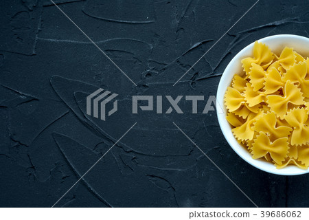 farfalle macaroni Pasta in a white bowl on a black 39686062