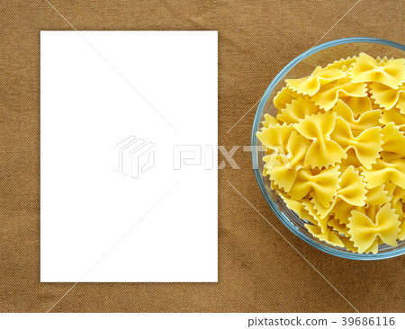 farfalle macaroni Pasta in a glass cup on a brown farfalle macaroni Pasta in a glass cup on a brown 39686116