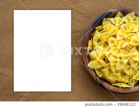 farfalle macaroni pasta in a wooden bowl on a 39686122