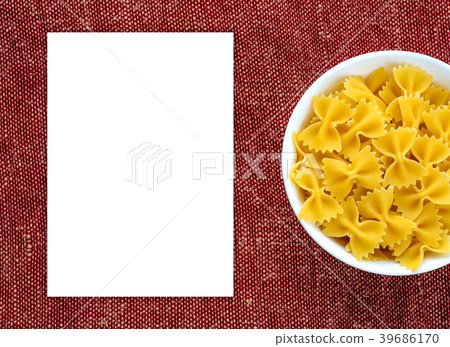 farfalle macaroni pasta in a white cup on a red farfalle macaroni pasta in a white cup on a red 39686170
