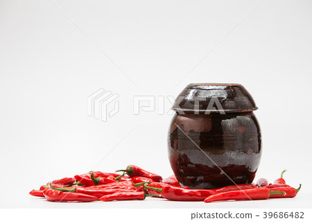 Chili peppers at Crock on white  39686482
