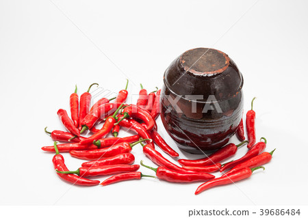Chili peppers at Crock on white  39686484