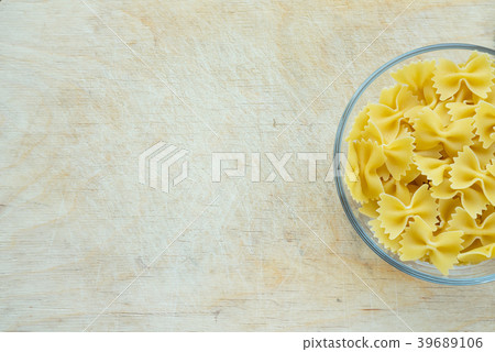 farfalle macaroni Pasta in a glass cup on a wooden 39689106