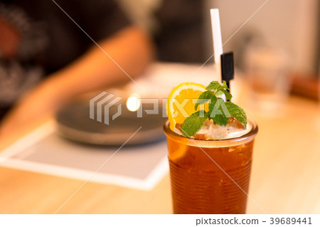 Iced tea with lemon and mint on the table 39689441