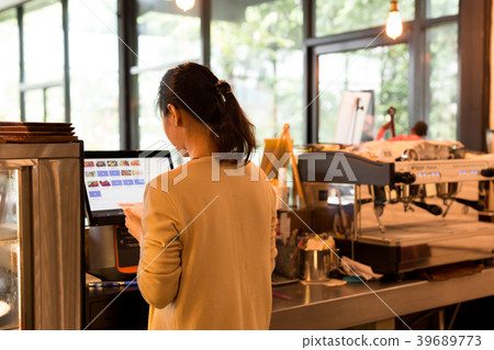 Woman at the cash register takes orders and bills  39689773