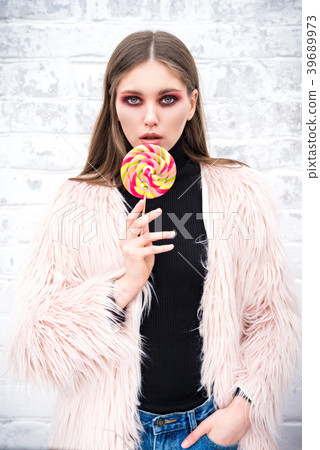 A girl with a multicolored lollipop 39689973