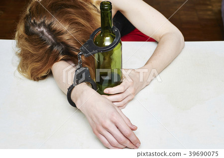 Girl asleep at a table 39690075