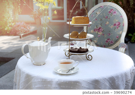 Afternoon tea with cup of tea and teapot and cake Afternoon tea with cup of tea and teapot and cake 39690274