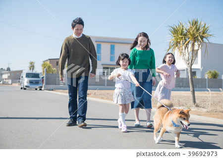 Two elementary school sisters and their family taking a walk of Shiba Inu 39692973