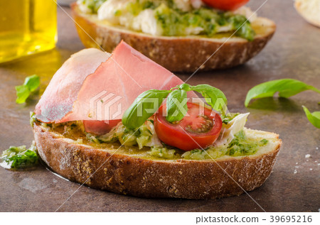 Toasted Tuscan bread with pesto Toasted Tuscan bread with pesto 39695216