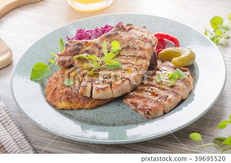 Grilled pork chops with herbs and garlic, potato pancakes Grilled pork chops with herbs and garlic, potato pancakes 39695520