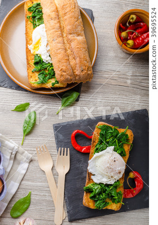 Toasted baguette with poached egg Toasted baguette with poached egg 39695524