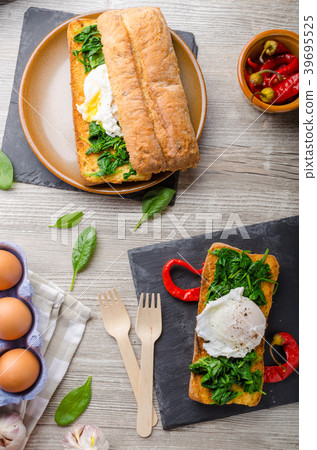 Toasted baguette with poached egg Toasted baguette with poached egg 39695525