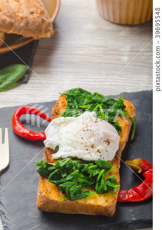 Toasted baguette with poached egg Toasted baguette with poached egg 39695548