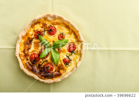 Quiche with cheese and cherry tomatoes 39696622