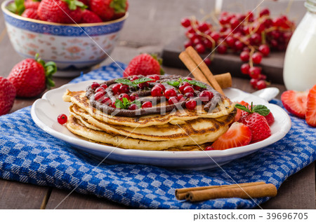 Cinnamon pancakes with chocolate sauce and berries 39696705