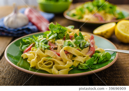 Tagliatelle with bacon, garlic and salad 39696909