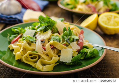 Tagliatelle with bacon, garlic and salad 39696918