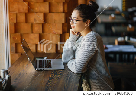 girl working on a laptop at a restaurant girl working on a laptop at a restaurant 39698166