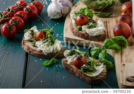 Grilled toasts with pesto Grilled toasts with pesto 39700230