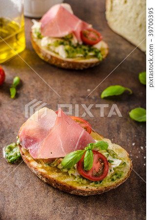 Toasted Tuscan bread with pesto Toasted Tuscan bread with pesto 39700395