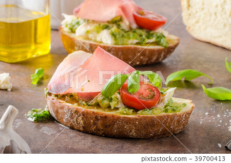 Toasted Tuscan bread with pesto Toasted Tuscan bread with pesto 39700413