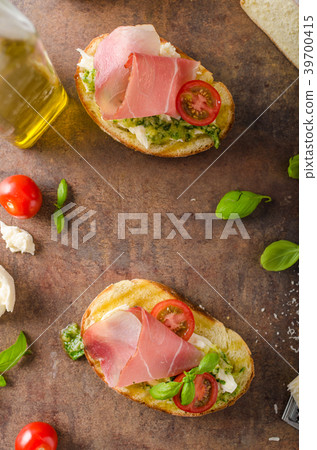 Toasted Tuscan bread with pesto Toasted Tuscan bread with pesto 39700415