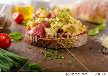Delicious toasted bread with scrambled eggs Delicious toasted bread with scrambled eggs 39700421